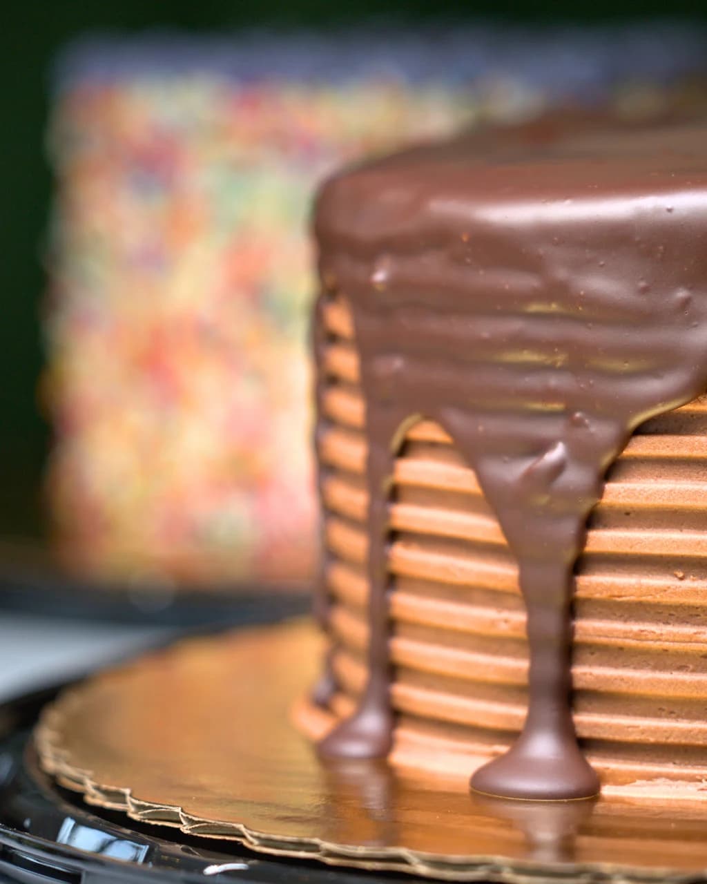 A vegan cake under a thick chocolate drip