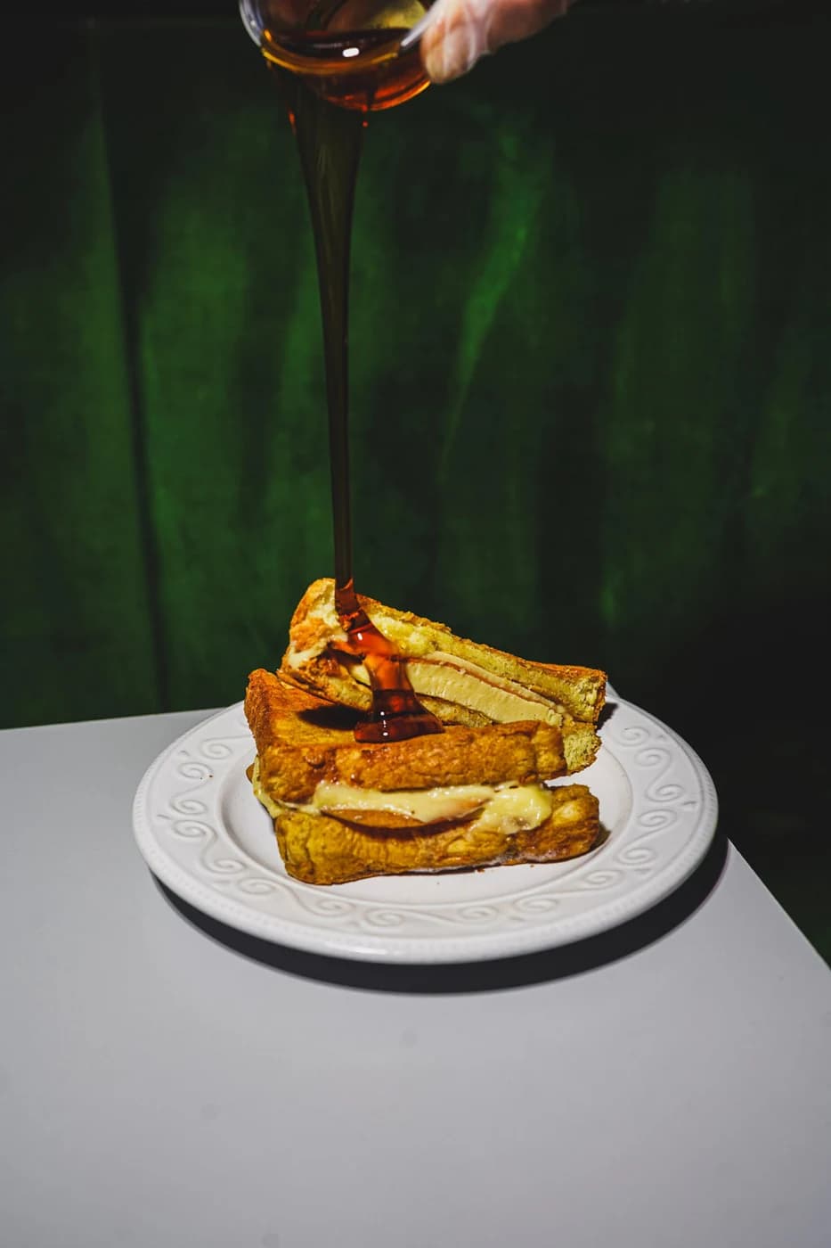 Syrup being poured over stuffed french toast
