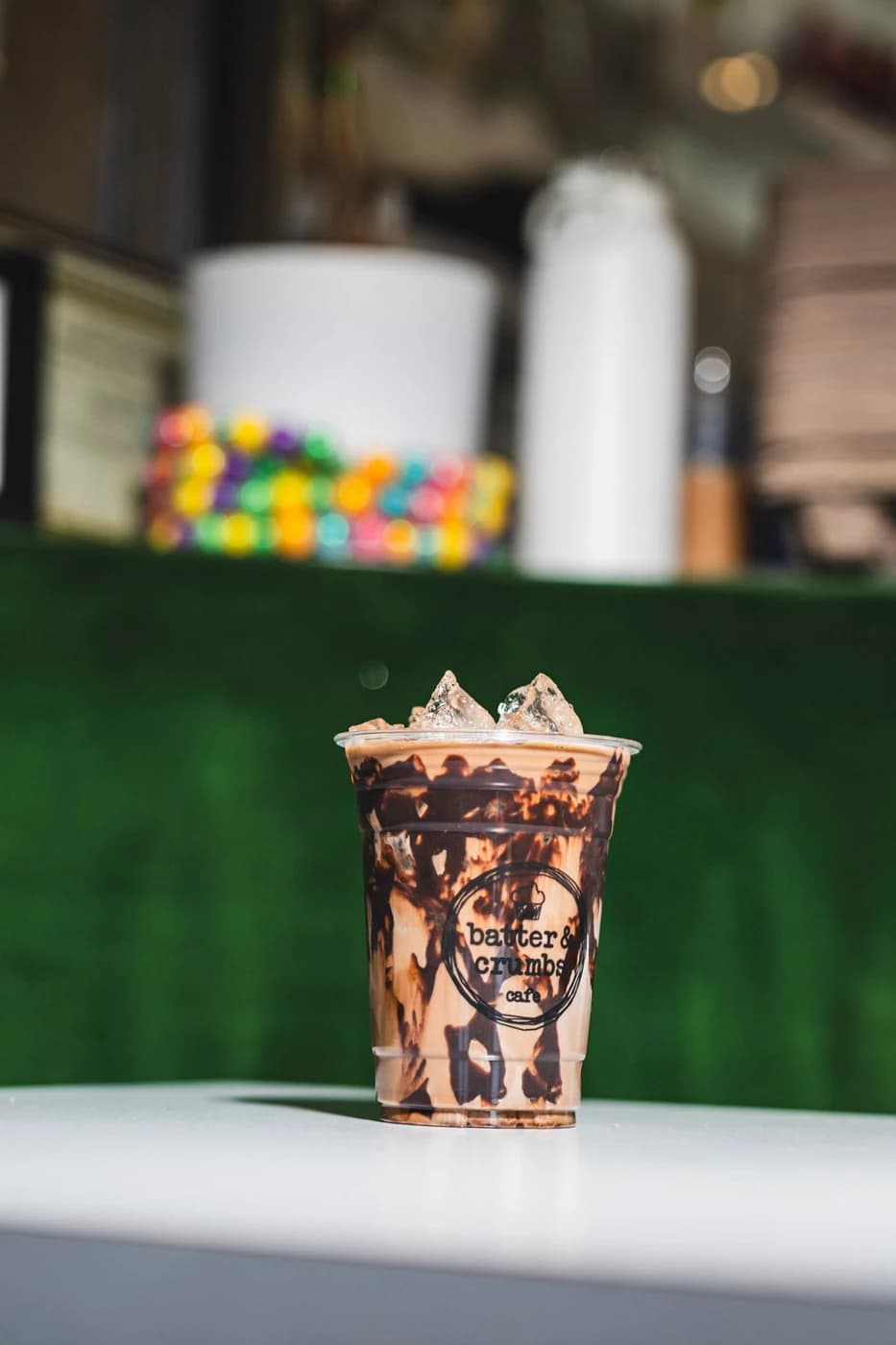 An iced mocha with whipped cream and chocolate drizzle