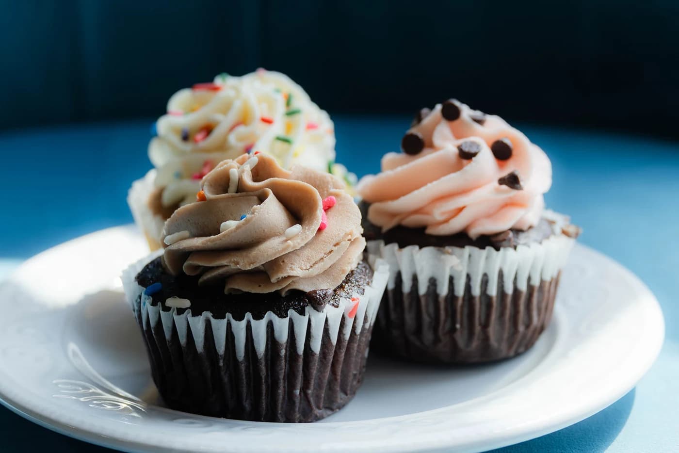 Two frosted vegan cupcakes on a plate